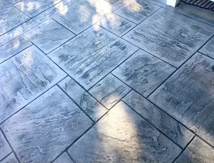 Textured gray stamped concrete patio with a stone-like pattern.