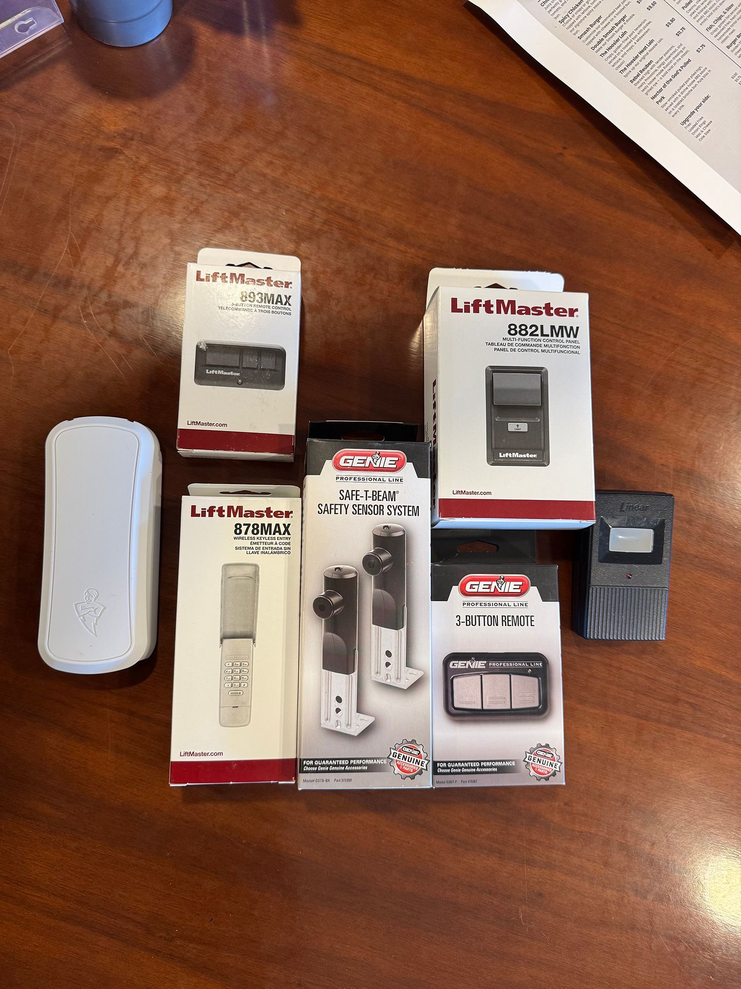 Assorted Lutron home lighting control devices and remotes arranged on a wooden table.