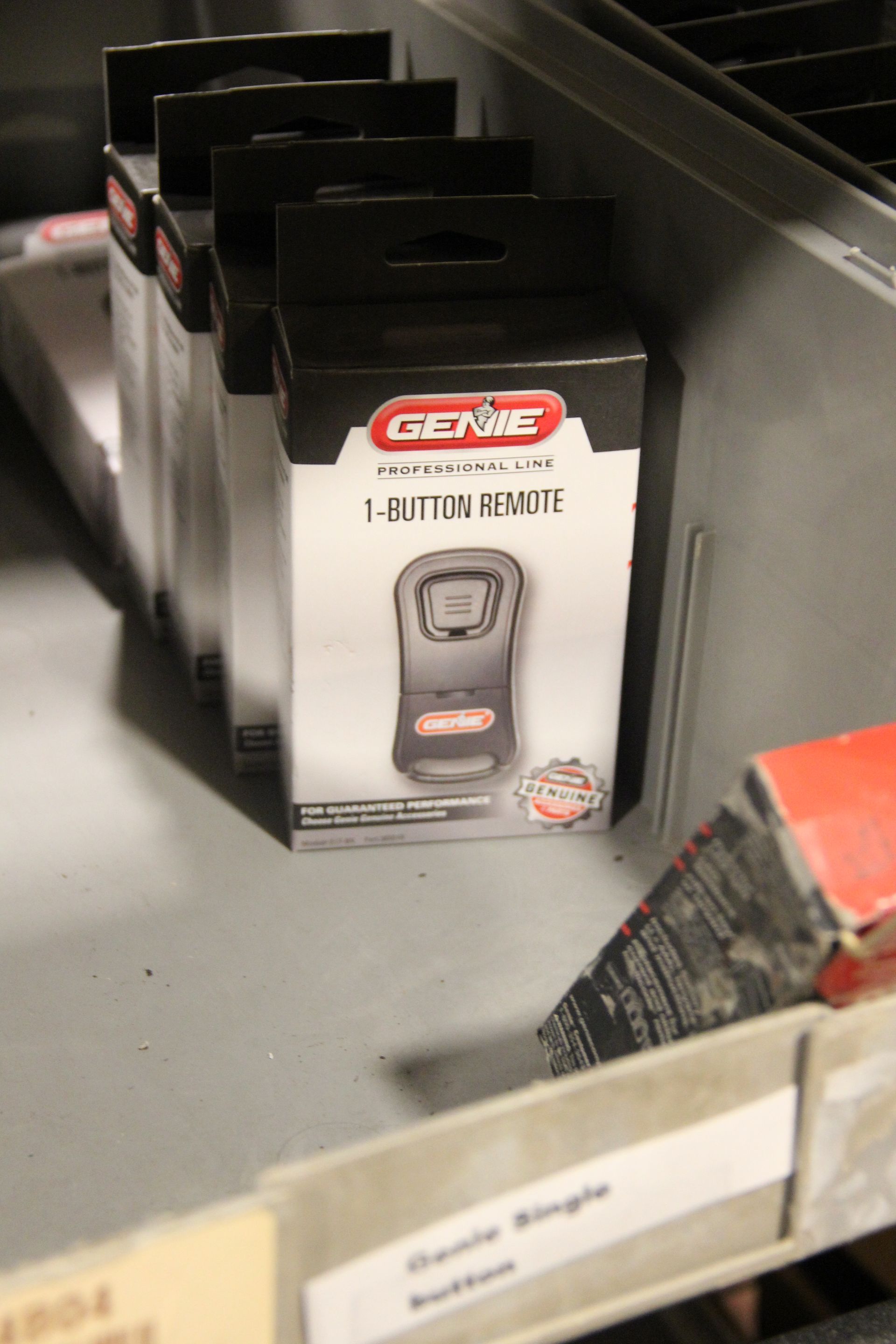 Shelf of black-and-red battery charger packages in a store aisle