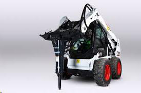 White Bobcat skid-steer loader with a hydraulic hammer attachment, used for breaking concrete.