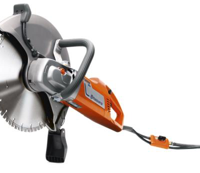 Orange and gray Husqvarna electric cut-off saw with a large blade and safety guard.