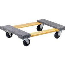 Wooden dolly with four black wheels and gray padded corners.