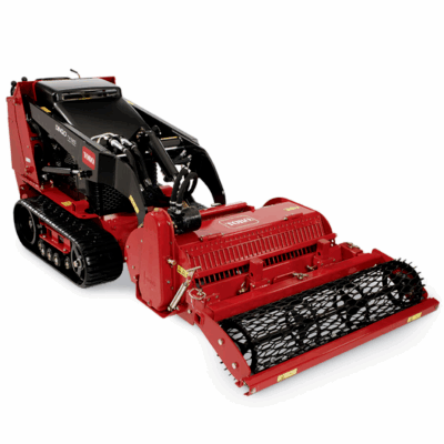 Red Toro Dingo TX 1000 compact utility loader with soil renovator attachment, on white background.