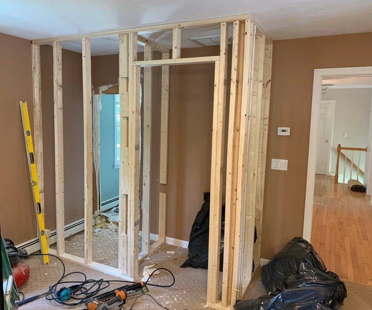A room is being built with wooden walls and a door.