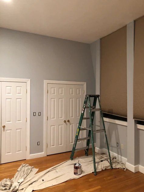 A room that is being painted with a ladder in it