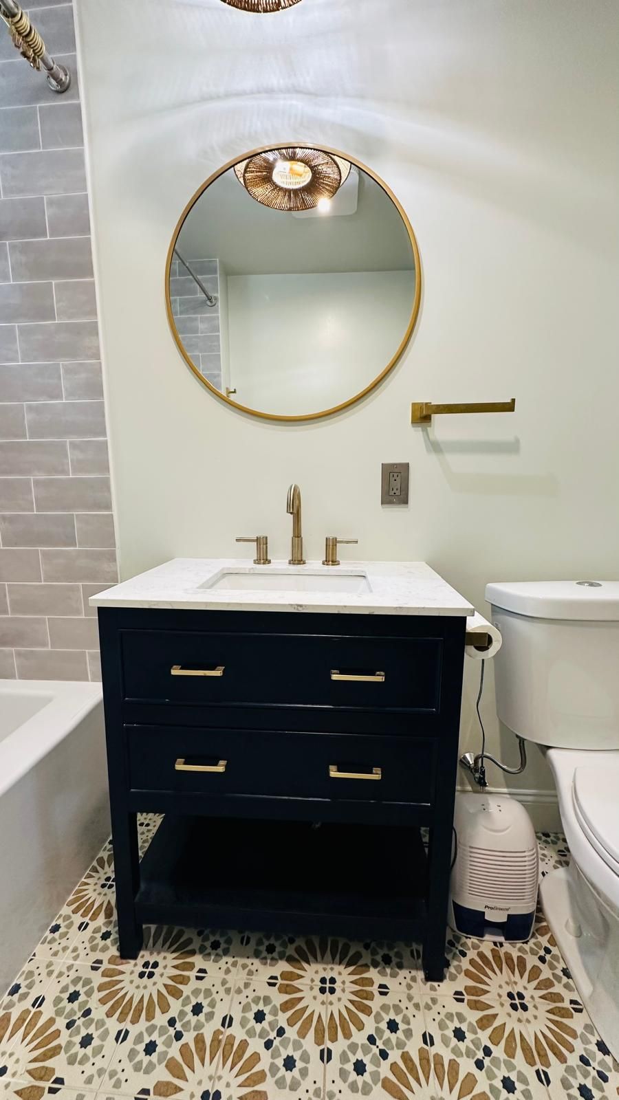An elegant bathroom with a sink, toilet, and mirror.