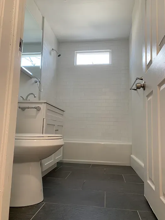 A bathroom with a toilet , sink , tub and shower.