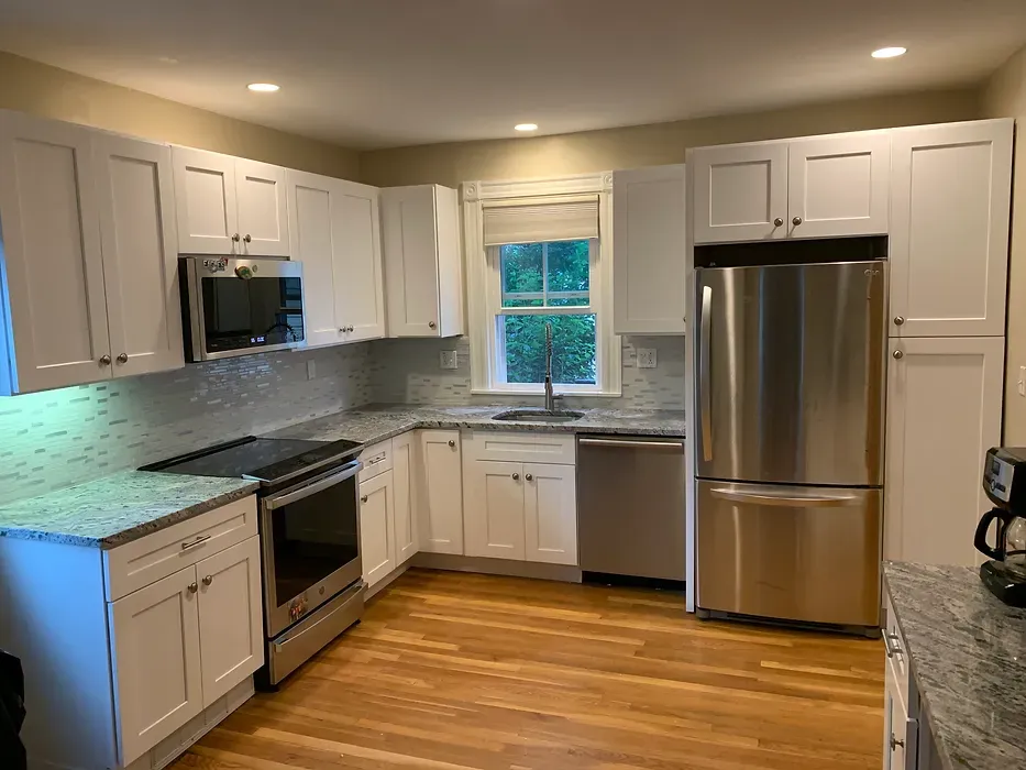 A kitchen with white cabinets and stainless steel appliances.