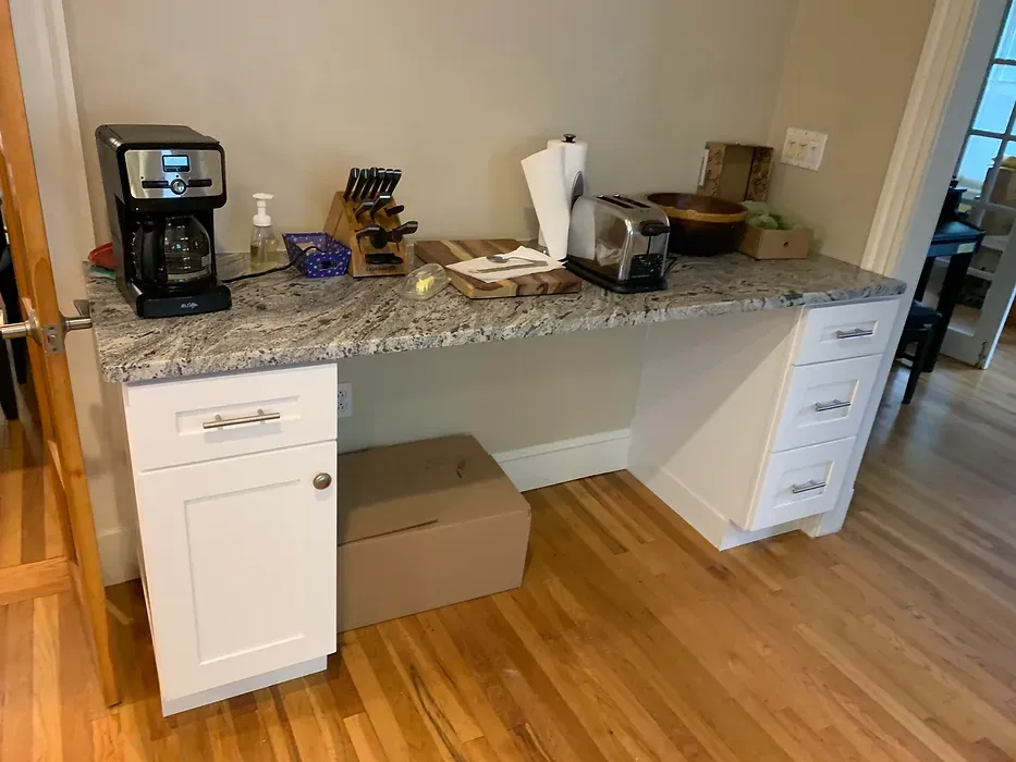 A kitchen counter with a coffee maker and a toaster oven on it.