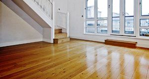 An empty room with hardwood floor