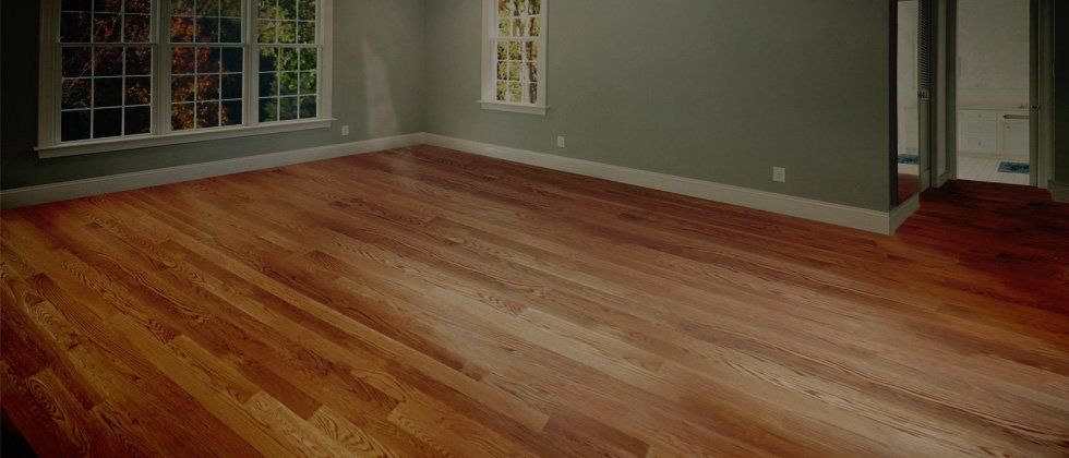 An empty room with hardwood floors