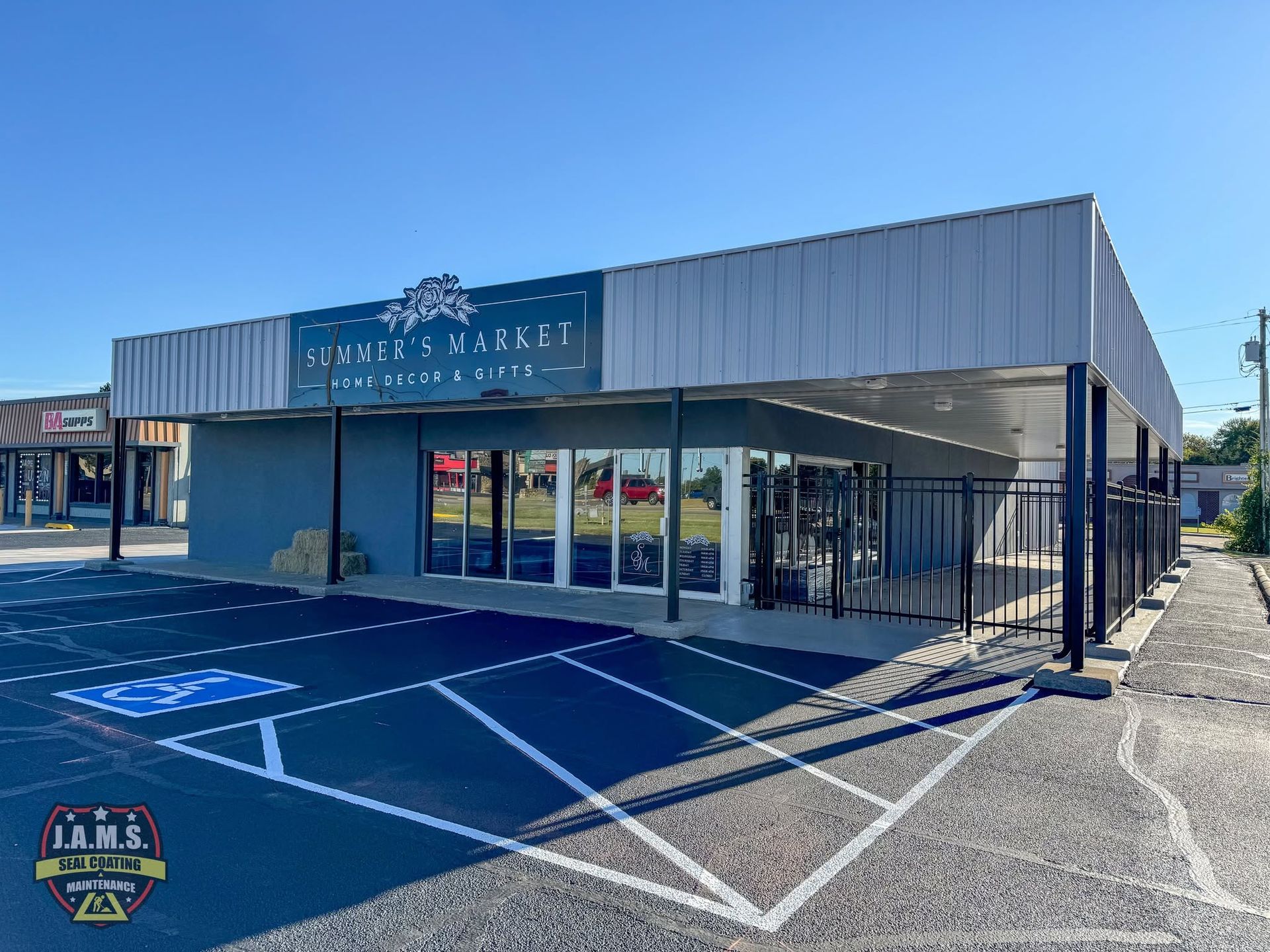 Small storefront with blue awning, glass windows, and handicap parking spaces in front.