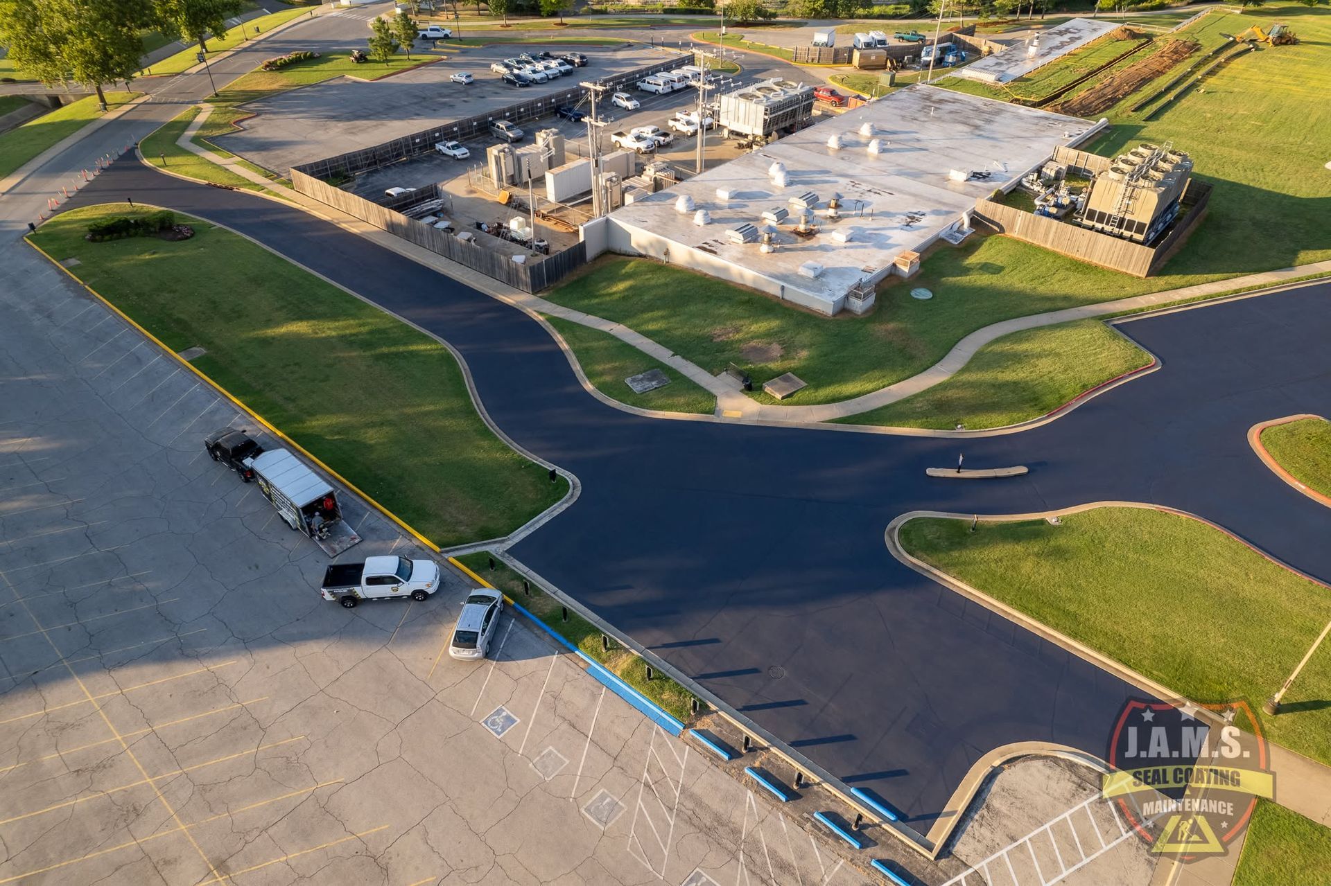 Aerial view of a school campus with parking lots, roads, and buildings at dusk.