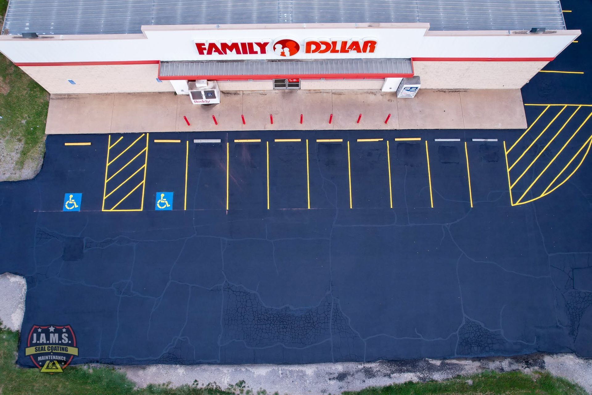 Aerial view of a Family Dollar storefront with mostly empty parking spaces and blue handicap spots.