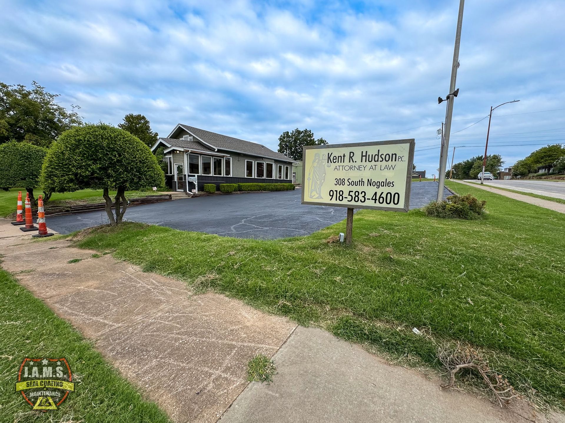 Office building with a sign for Park E. Taylor Law on a grassy roadside corner