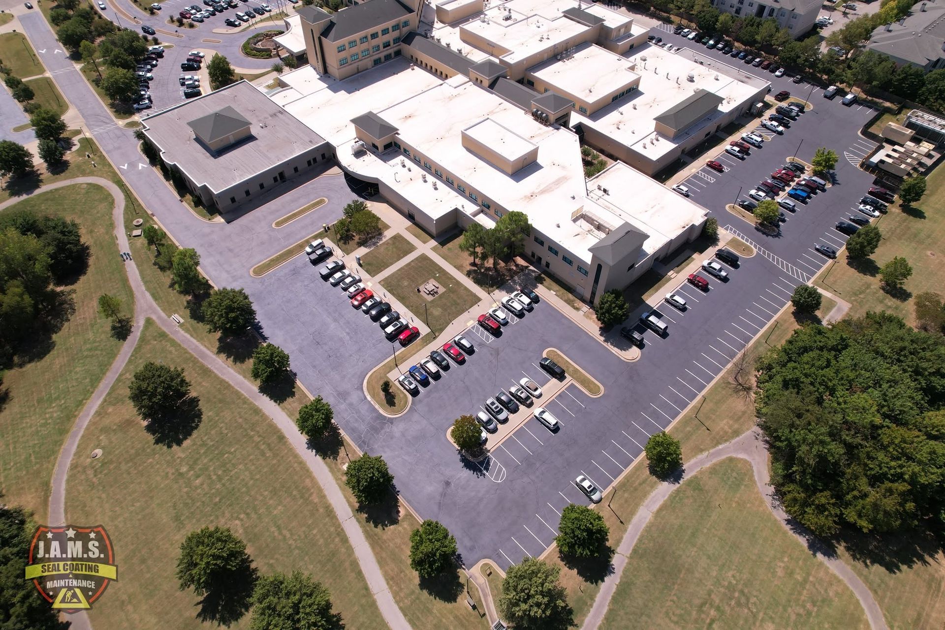Aerial view of a large office complex with parking lots and surrounding green space.