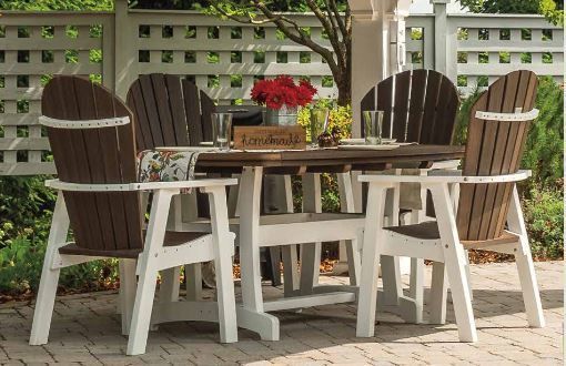 Patio dining set with four brown and white Adirondack chairs around a table under a white pergola.