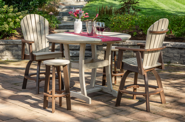 Patio set with round table, 2 chairs, & stool; table setting with wine & flowers, on a brick patio.