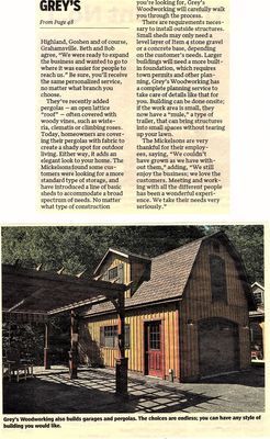 A wood-paneled garage with a covered patio, brown roof and a red door.