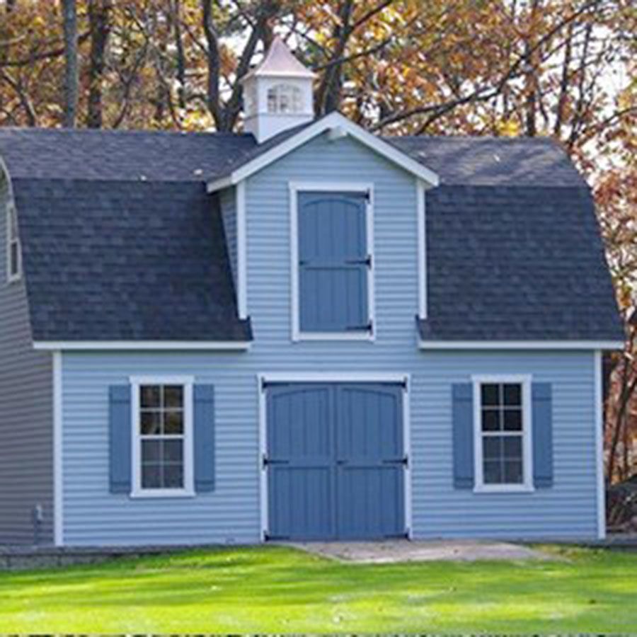Blue barn with black roof, white trim, and a copper cupola.