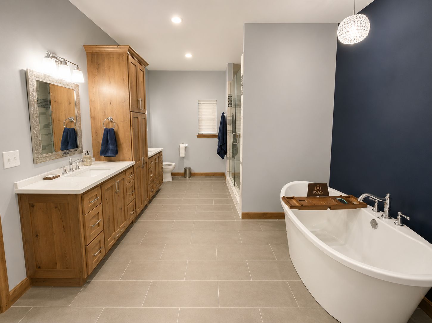 Modern bathroom with wood vanity, large mirror, and freestanding white tub