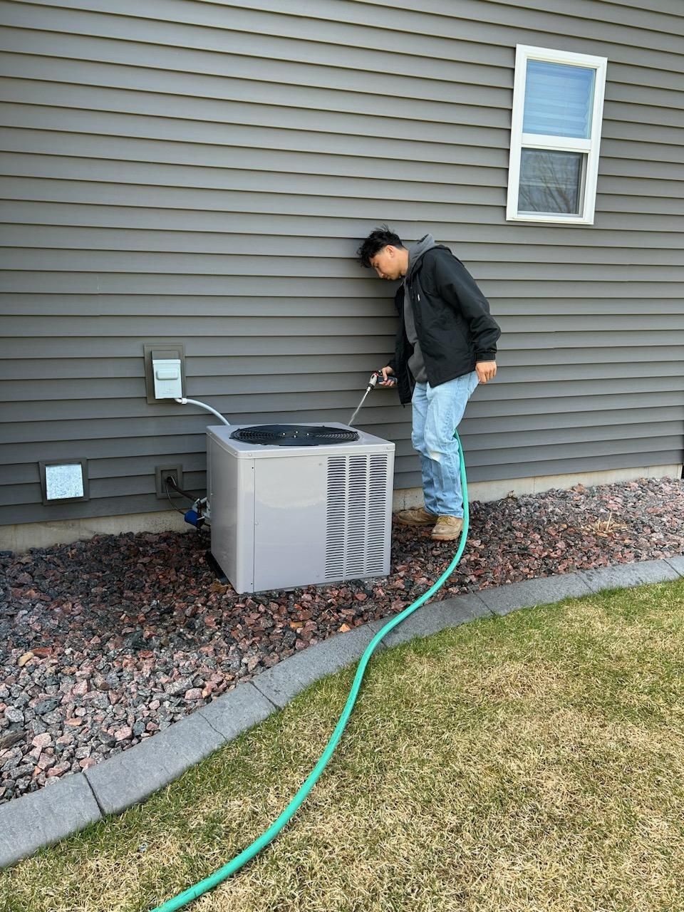 Man cleaning an AC unit