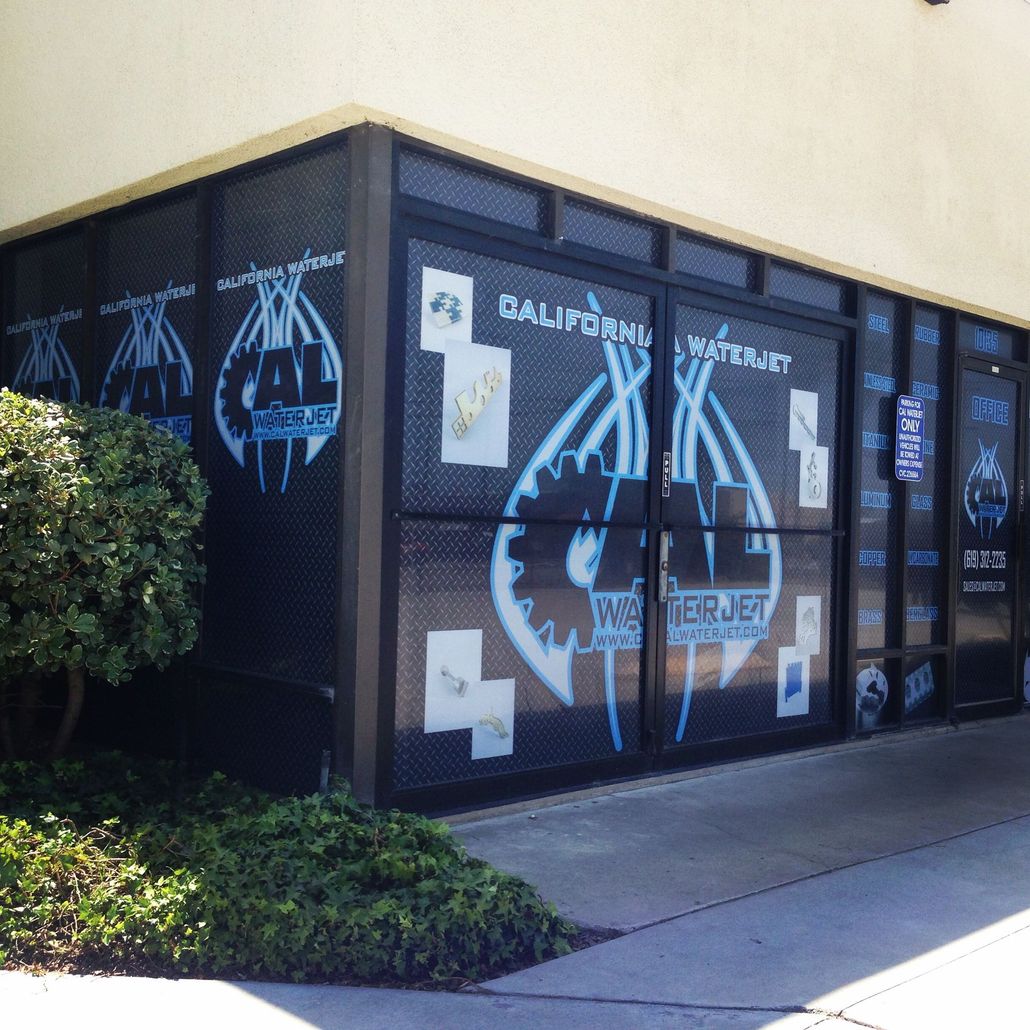 California Waterjet building with blue logo on black background.