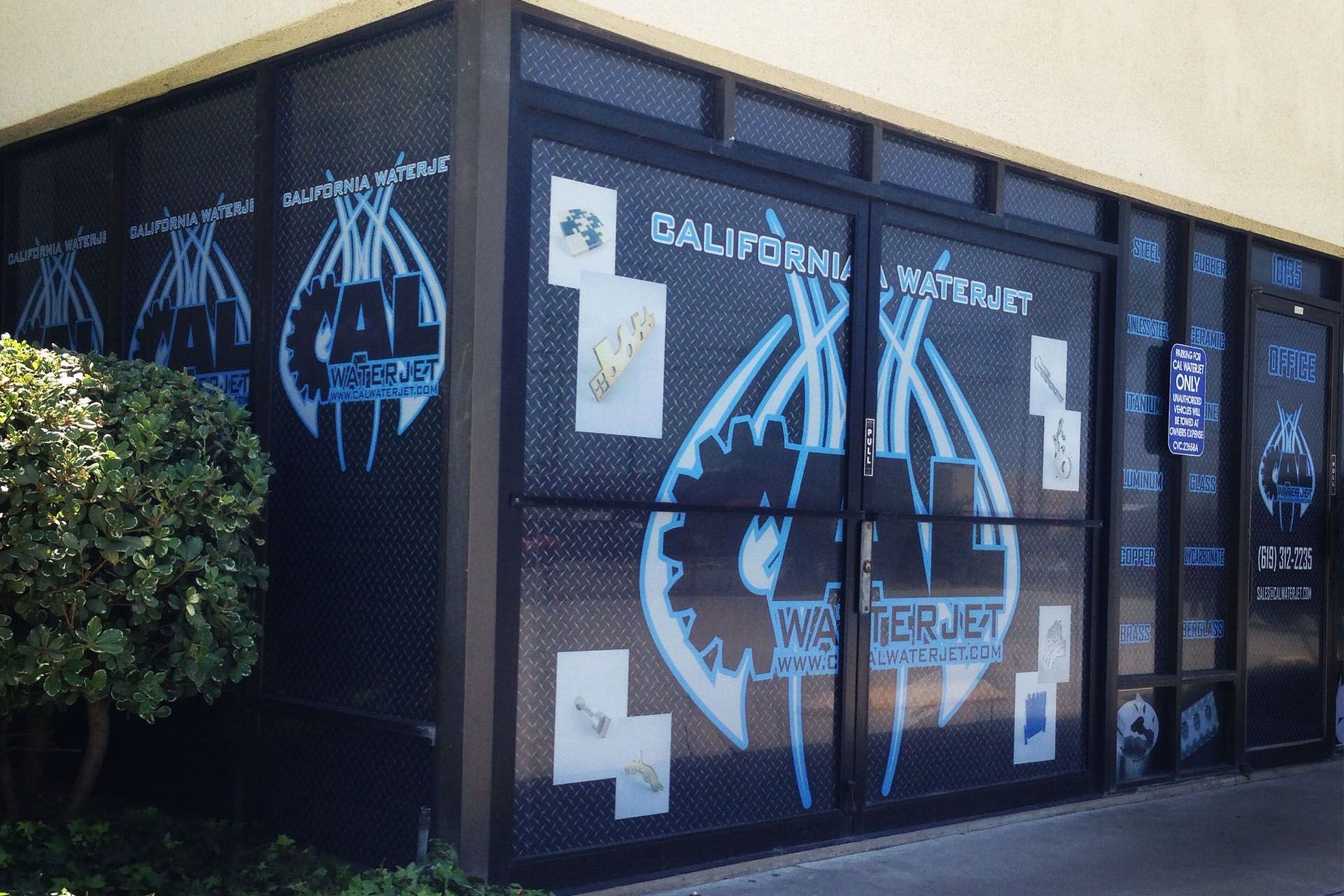 California Waterjet building with blue logo on black background.