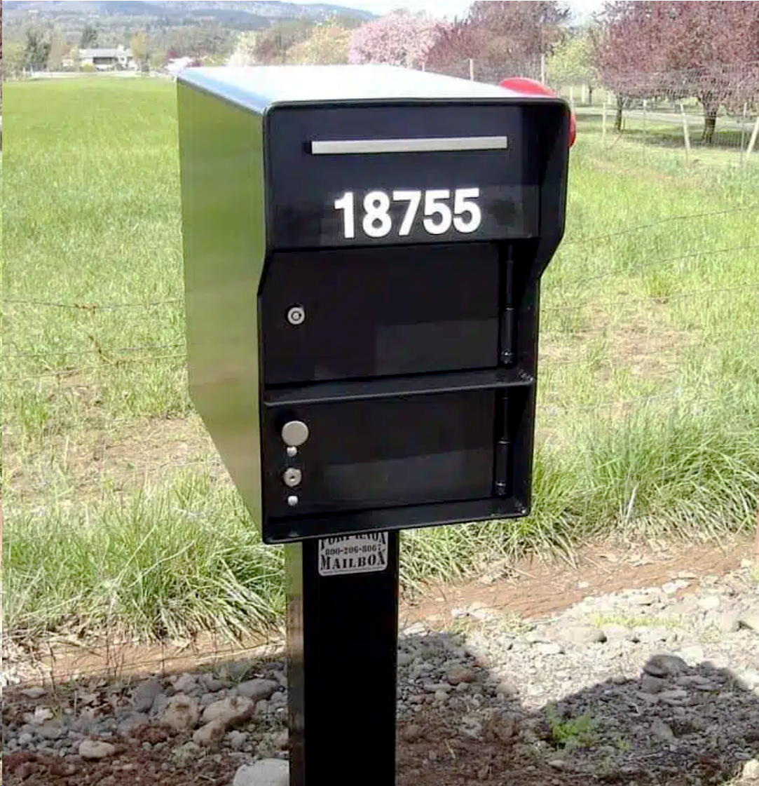 A black mailbox with the number 18755 on it