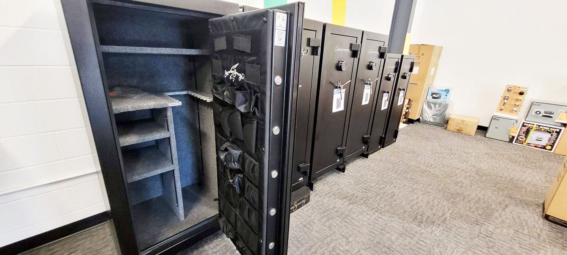 A row of safes are lined up in a room.
