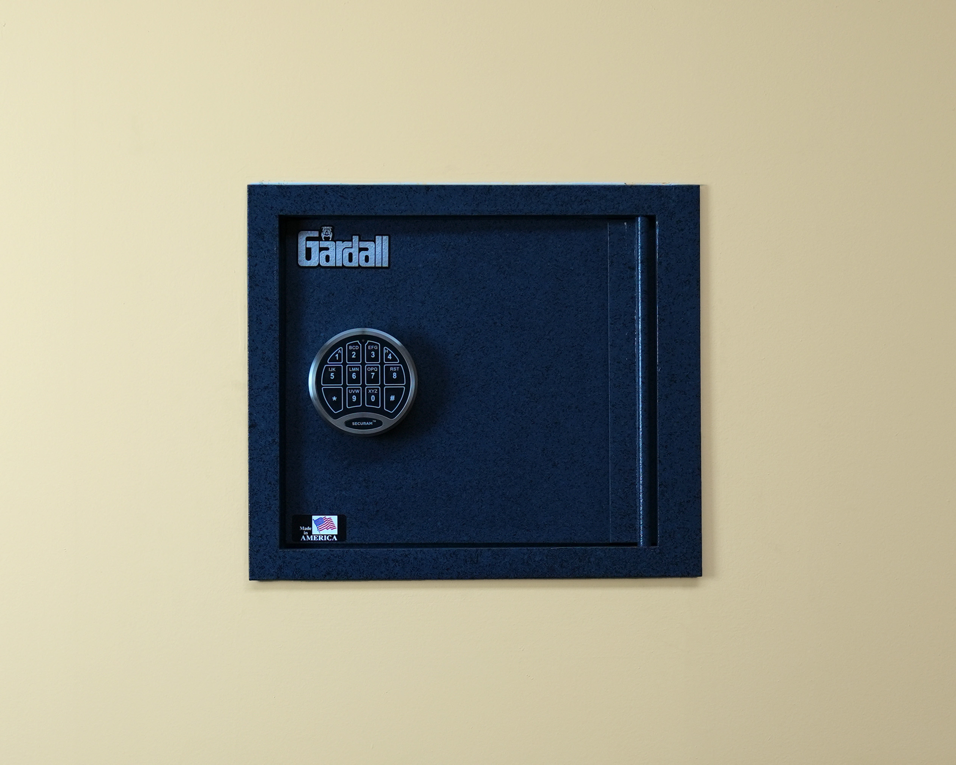 A blue safe with a digital lock is hanging on a wall