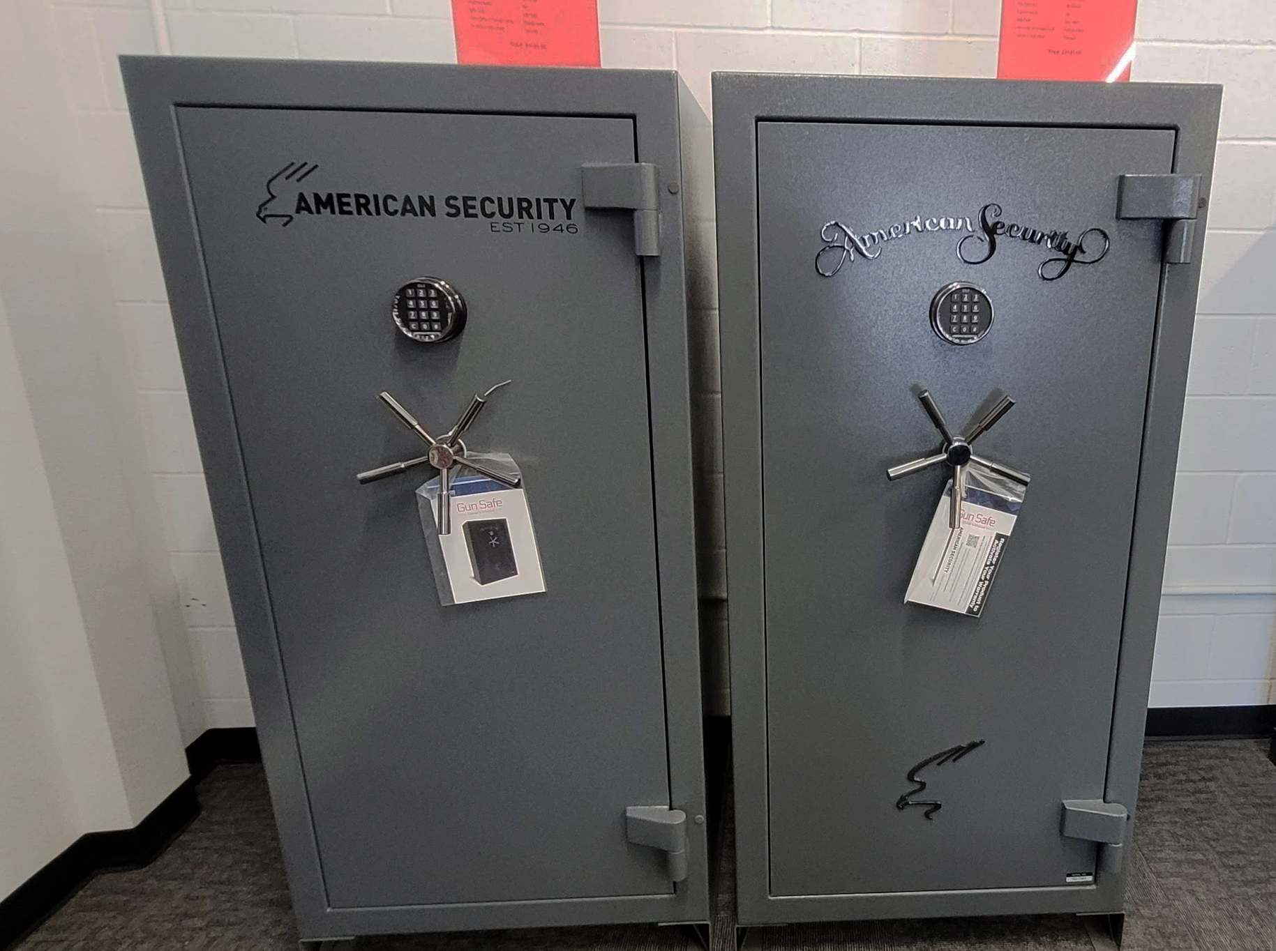 Two american security safes are sitting next to each other in a room.