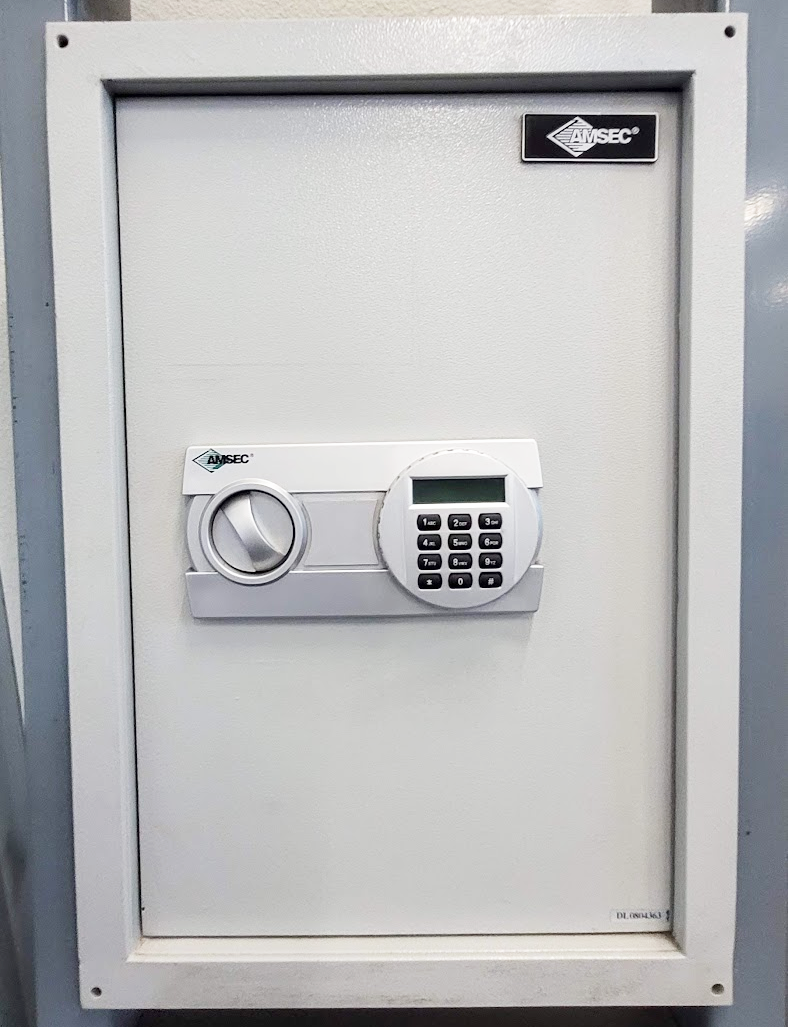 A white safe with a digital lock on it