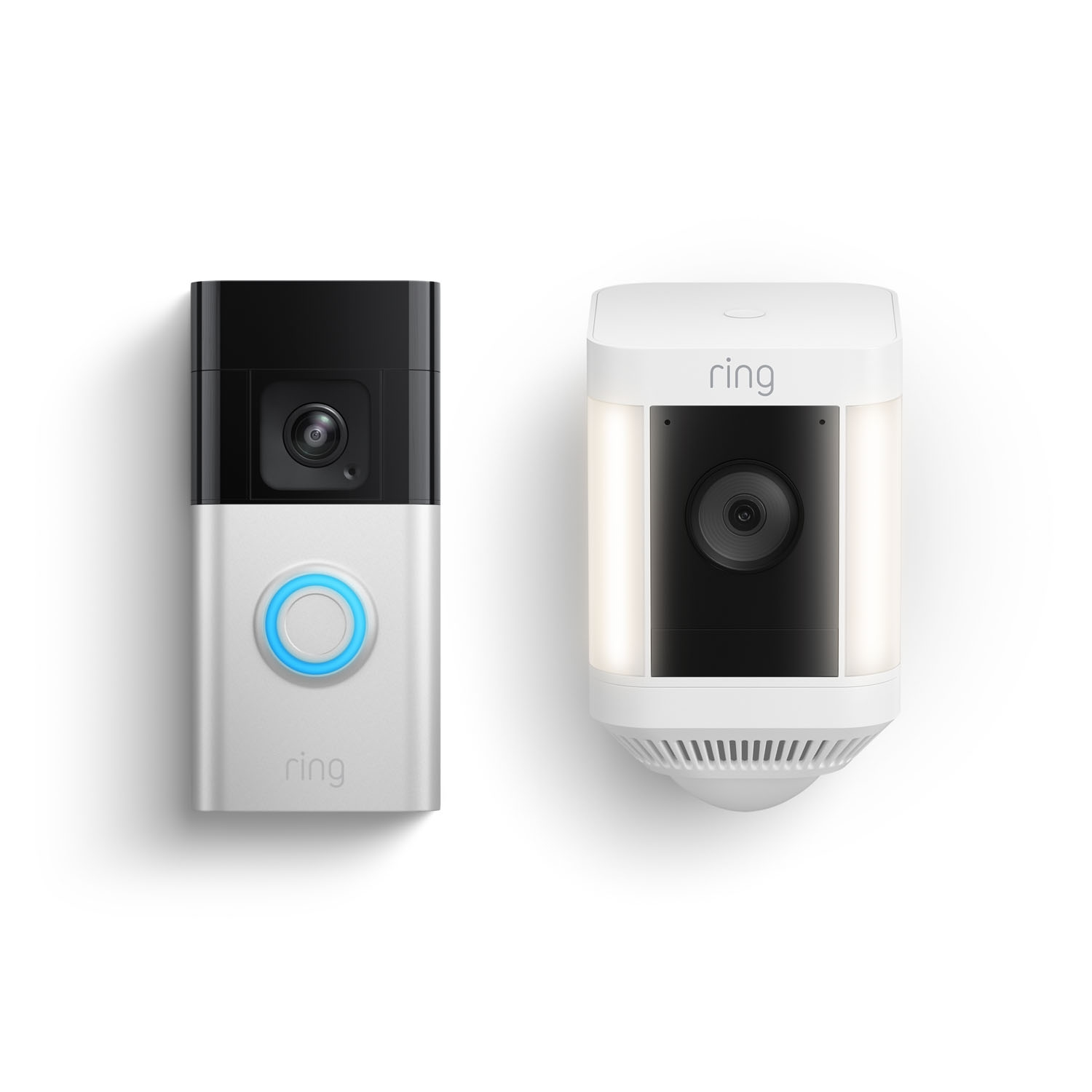 A ring doorbell and a ring camera are sitting next to each other on a white surface.