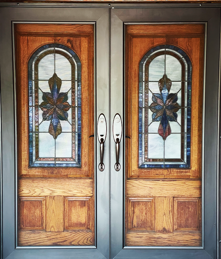 A pair of wooden doors with stained glass windows