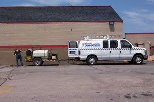 A plumber cleaning sewer drain