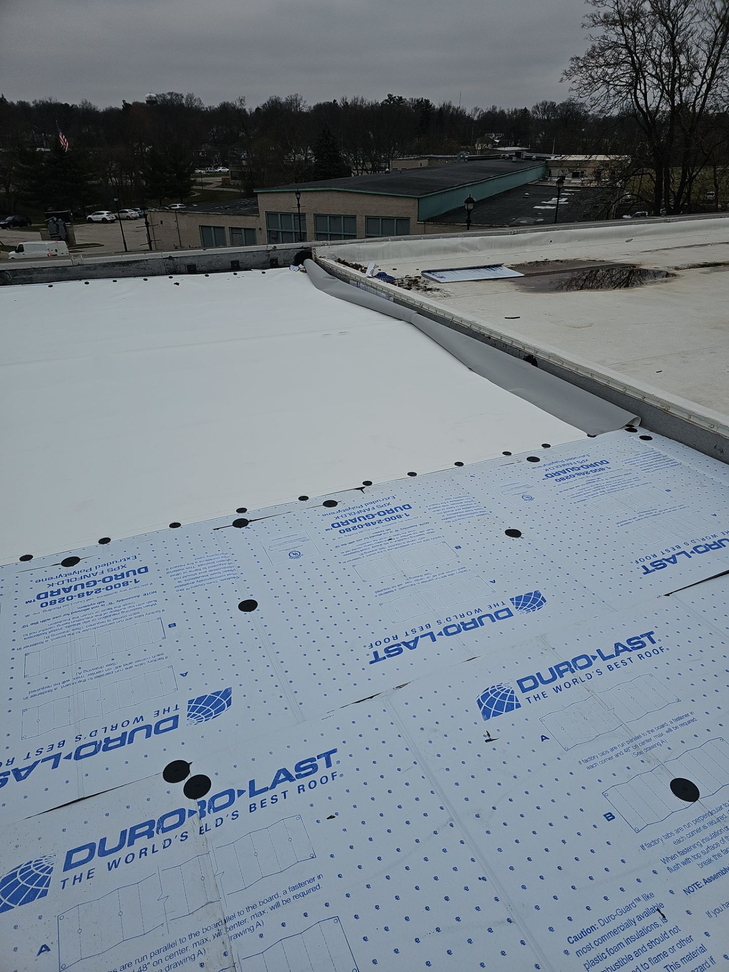 A view of a flat roof undergoing installation, showing Duro-Last insulation boards laid out before the final membrane.