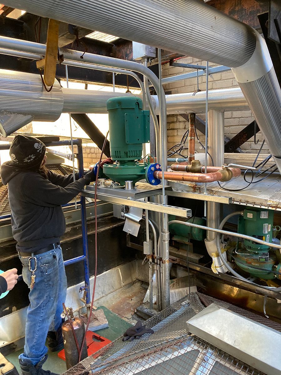 A man is working on a machine in a factory.