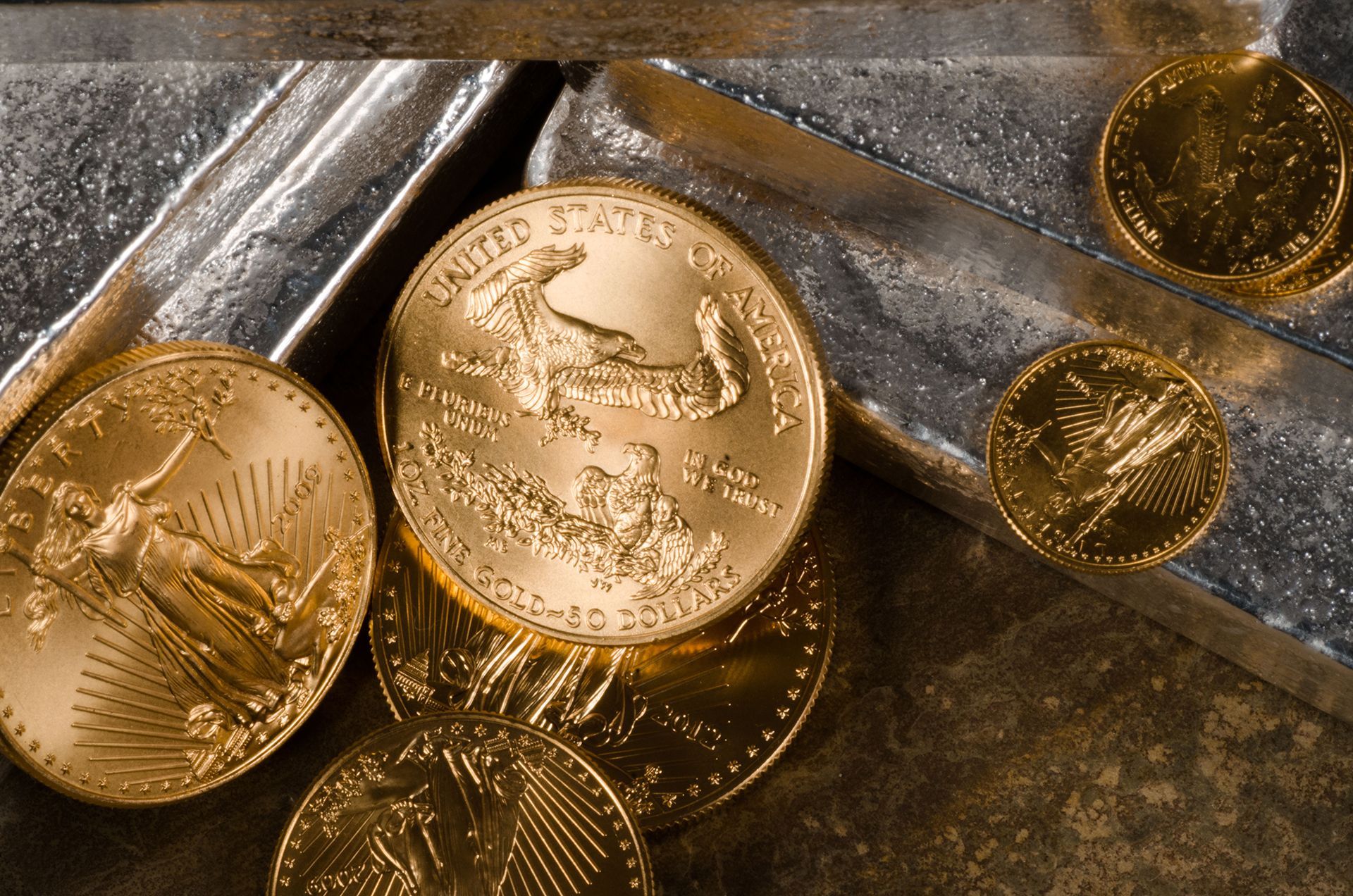 American gold eagle coins laying on silver bars