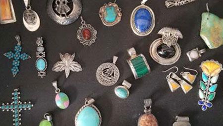 There are many different types of jewelry on the table.