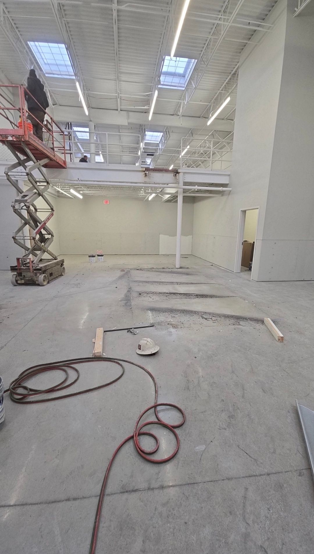 Empty warehouse interior with a scissor lift