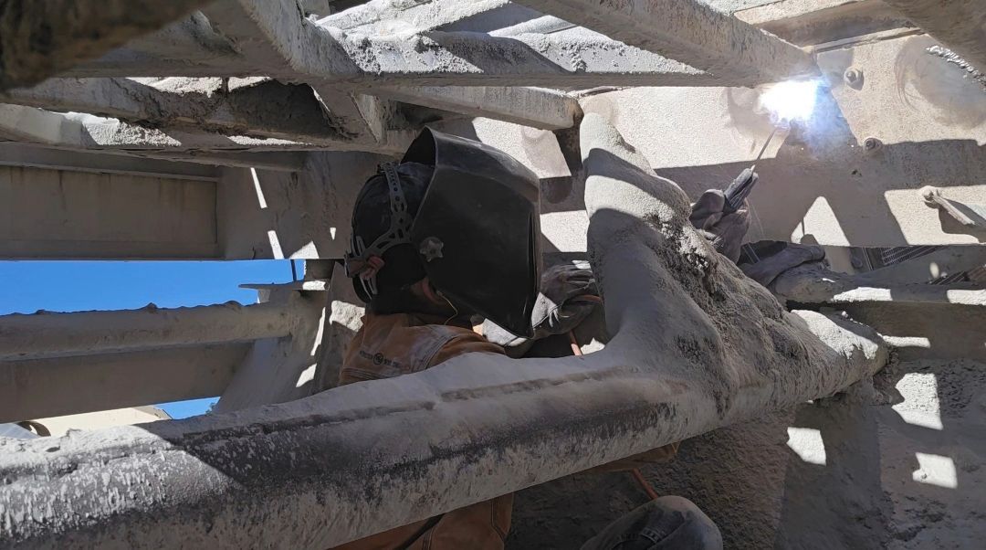 A worker welding a metal