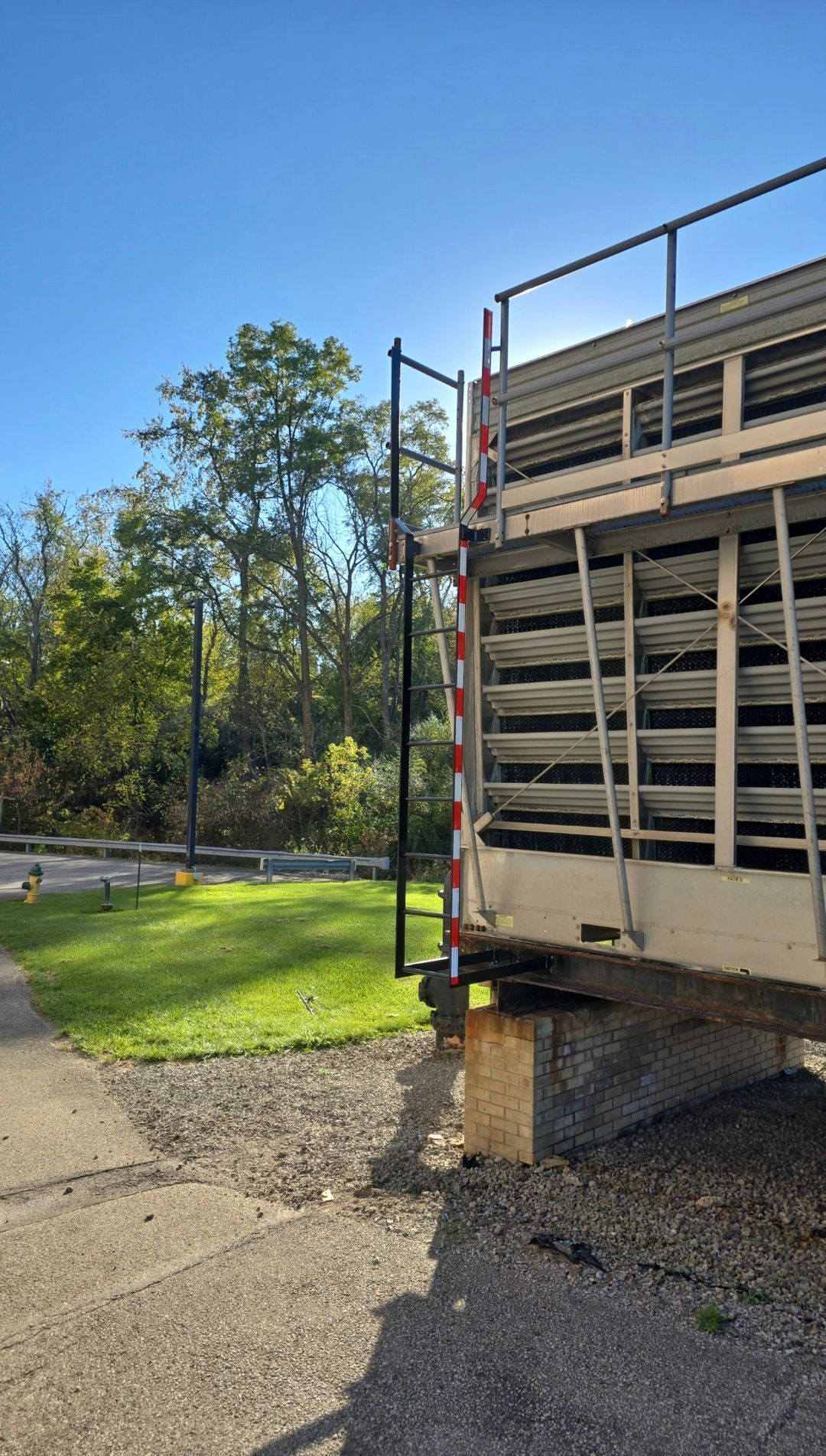 A fixed vertical access ladder is attached to the side of the structure