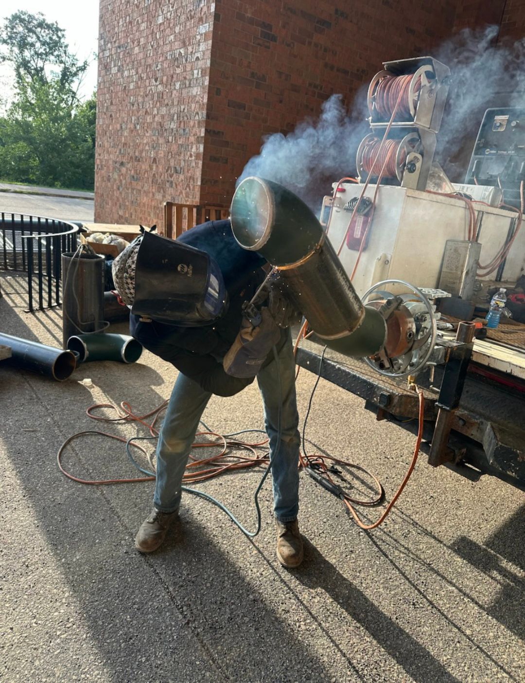 A worker welding a metal