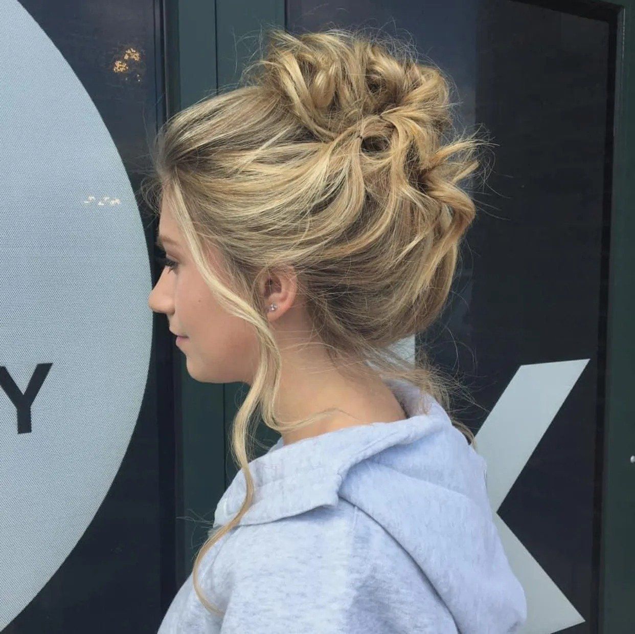 A woman with blonde hair in a messy bun