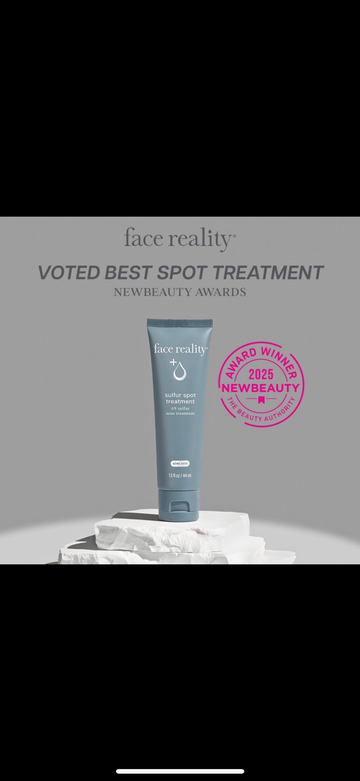 A tube of lotion is sitting on top of a pile of rocks.