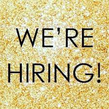 A sign that says `` we 're hiring '' on a gold background.