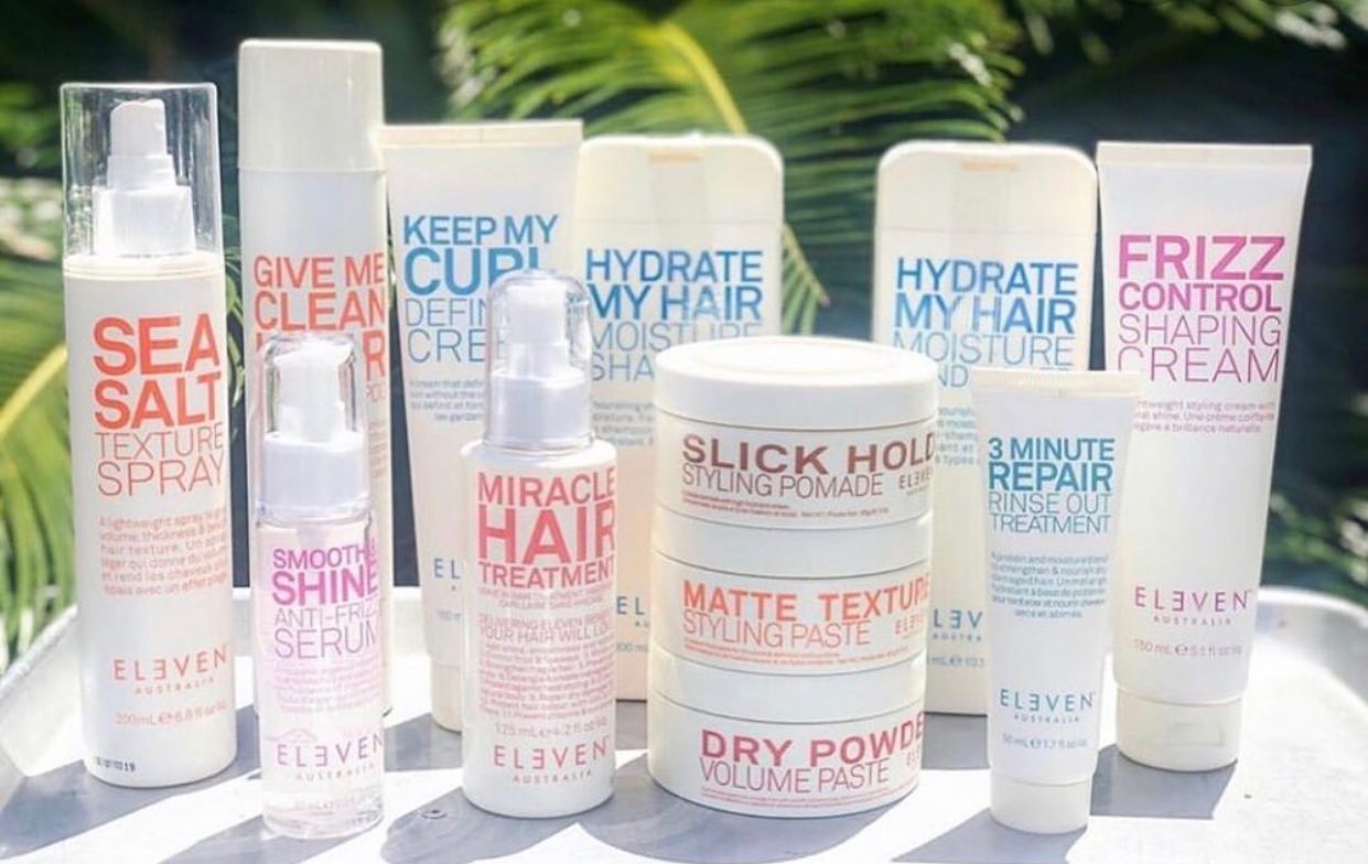 A bunch of hair products are sitting on a table.