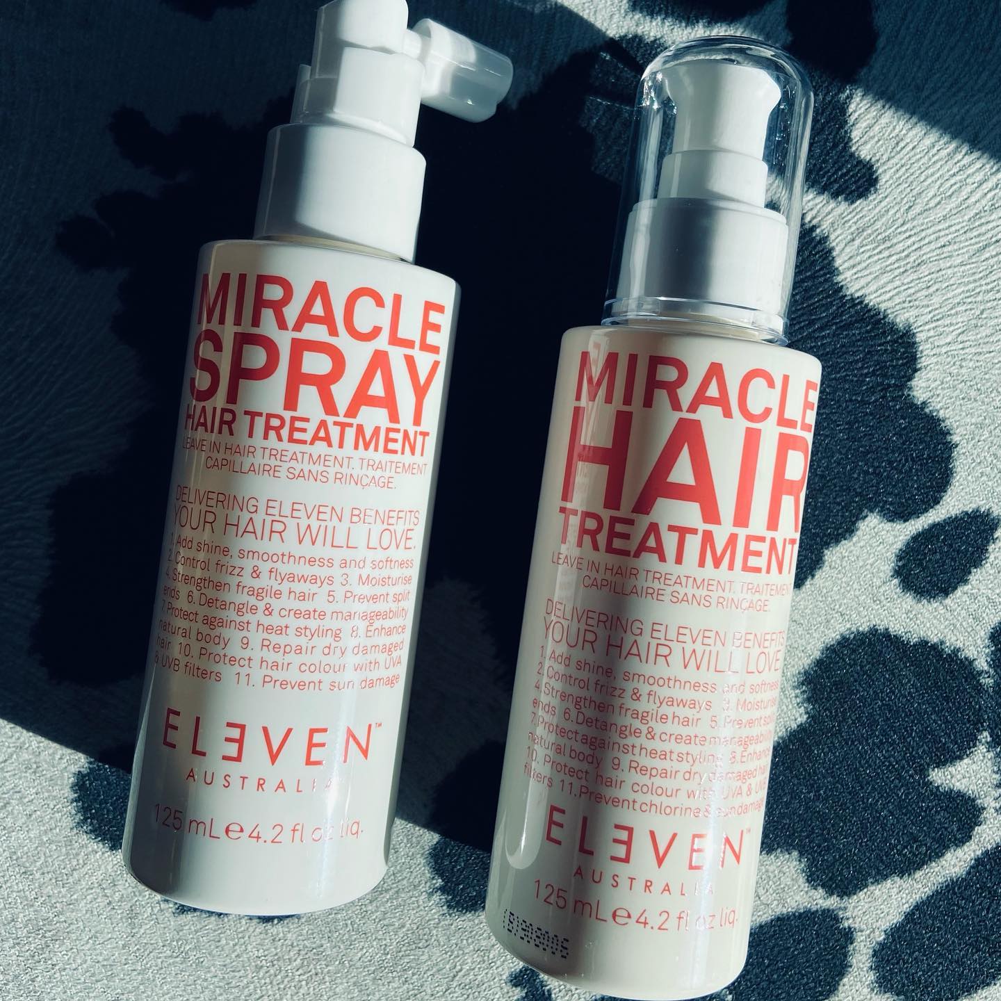Two bottles of miracle spray hair treatment by eleven