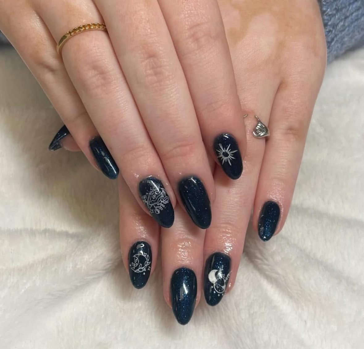 A close up of a woman 's nails with snowflakes on them